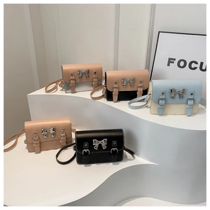 Chic women's bow satchel bags in five colors displayed on minimalist white geometric stands