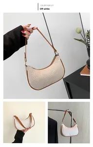 Detail of beige hobo bag with crocodile pattern and brown trim for women