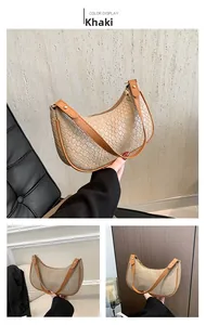 Detail of khaki hobo bag featuring woven texture and brown leather strap with gold hardware