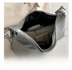 Detailed interior of a silver large capacity backpack showing storage for accessories