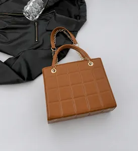 Detailed view of brown quilted PU leather bag with elegant gold chain strap and stitching