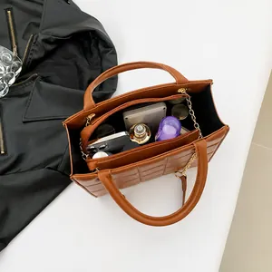 Detailed interior of quilted chain shoulder bag showing spacious storage for makeup