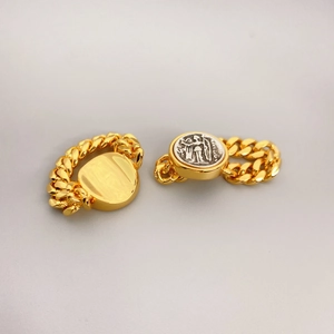 Vintage gold chain link rings featuring round silver relief coins for stylish women