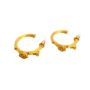 Golden C-shaped textured earrings featuring three-dimensional embossed rose flowers