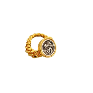 Vintage gold twist rope ring featuring a silver religious relief coin on white background