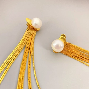 Boucles d'oreilles dorées à franges avec perles blanches au design vintage raffiné
