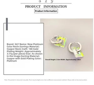 Detail view of silver-plated hoop earring with transparent resin square pendant