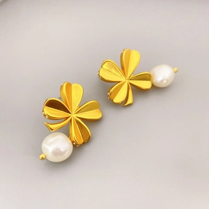 Elegant clover shape earrings with gold finish, sparkling crystals and white freshwater pearls