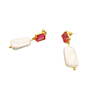 Elegant gold drop earrings featuring ruby red stones and baroque freshwater pearls