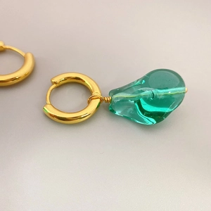 Fashionable gold hoop earrings featuring elegant deep green translucent glass waterdrop pendants