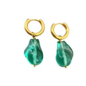 Fashionable gold hoop earrings with detachable green glass pendants on a white background