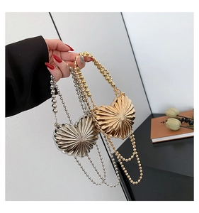 Detail showing gold and silver heart-shaped bags with radial pleated metal texture