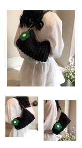 Detail showing black bubble texture shoulder bag with a green daisy charm on model