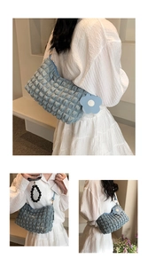 Detail of light blue popcorn texture shoulder bag with cute flower charm accessory