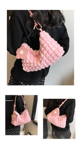 Detail of pink bubble texture nylon bag with floral charm and 3D pleated design