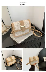 Detail view of khaki straw crossbody bag with brown leather trim and golden metal buckle