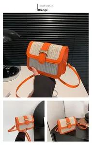 Detail view of the orange leather and straw patchwork crossbody bag with gold buckle