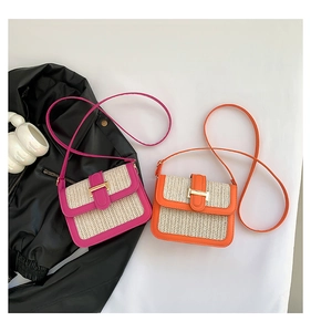 Detailed close-up of woven straw crossbody bags with orange and pink leather accents