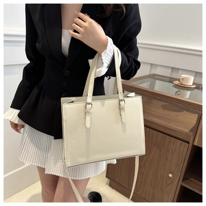 Chic beige tote bag styled with business casual attire for a professional look