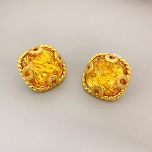 Vintage gold-tone earrings with yellow cracked resin stones and twisted metal frames