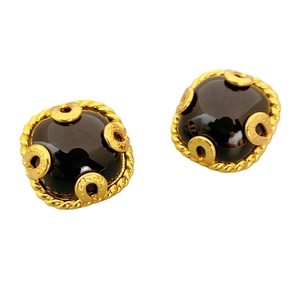 Vintage style gold earrings featuring large black cabochon gems and detailed brand engraving