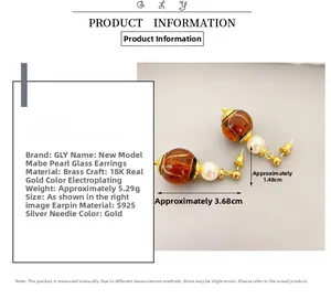Detail of amber glass and pearl drop earrings featuring S925 silver needles and 18K plating