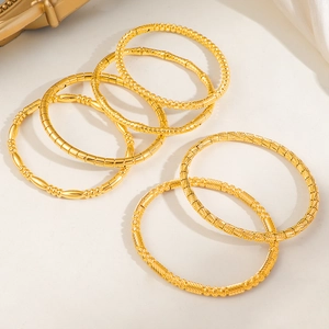 Set of 7 gold titanium steel bracelets with bead textures and minimalist geometric designs