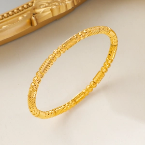 Chic gold titanium steel bracelet featuring spiral texture bars and geometric beads