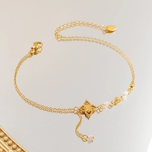 Elegant 18K gold floral anklet with white pearls and delicate double layer chain