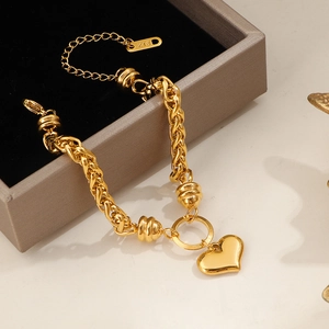 Golden heart pendant bracelet with chunky twisted chain and lobster clasp closure