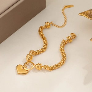 Gold plated titanium steel braided chain bracelet with heart pendant and K18 hallmark tag