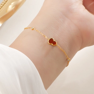 Elegant gold chain bracelet featuring a red wulu charm and sparkling zircon accents