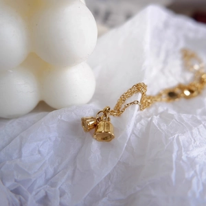Elegant 18k gold plated stainless steel lily of the valley necklace on white background