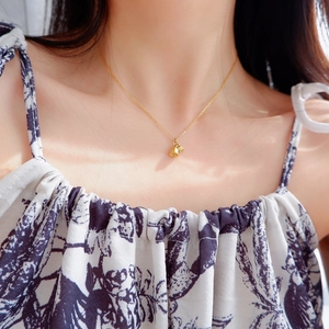 18k gold plated lily of the valley pendant necklace shown on a model neck