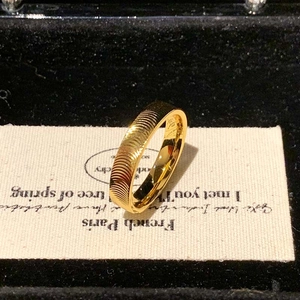 Gold plated stainless steel ring with cat-eye ripple texture and polished finish