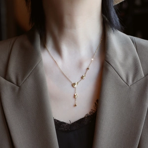 Elegant gold-tone Y-shape gourd tassel necklace for women on minimalist khaki blazer