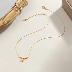 Golden titanium steel necklace with Fu character pendant and small square beads