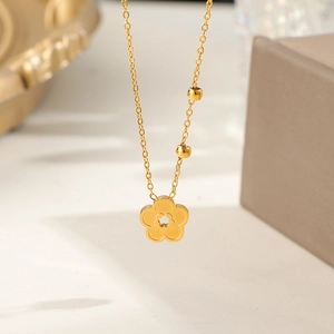 Minimalist gold plated titanium steel necklace featuring a hollow peach blossom flower pendant