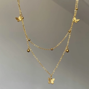 Collier double épaisseur doré avec papillons et perles métalliques pour femme