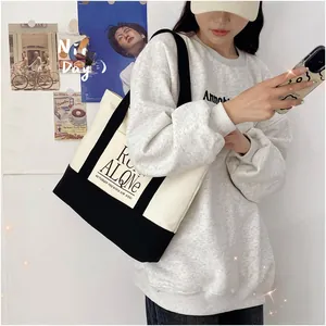 Lifestyle shot of large contrast canvas tote bag with Run Alone print worn by a model