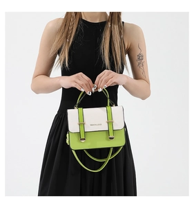 Detail of green contrast crossbody bag with top handle and Fashion & Bags lettering