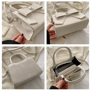 Détails du sac crème à nœud montrant le compartiment interne et le cristal en cœur