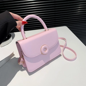 Pink lychee grain leather crossbody bag with gold round buckle and top handle
