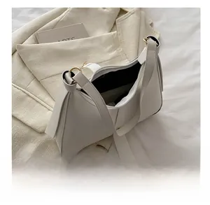 Close-up of a white leather hobo bag showing spacious interior and smooth matte finish