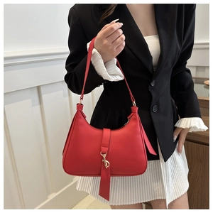 Minimalist red leather hobo underarm bag with gold hook and slim strap on female model