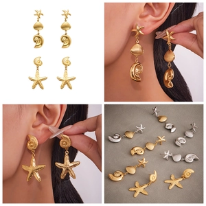 Detail showing long stainless steel ocean earrings with starfish and seashell charms