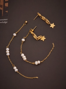 Detailed view of 18k gold star earrings with elegant long freshwater pearl tassels