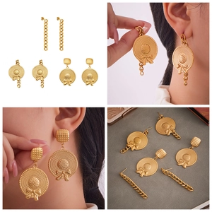 Macro view of vintage 18k gold plated chain earrings with bow and hat design detail