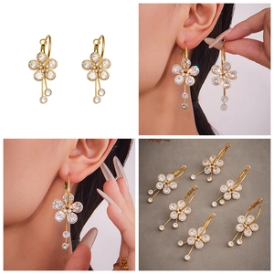 Macro detail of 18k gold plated flower earrings with sparkling 5A cubic zirconia stones