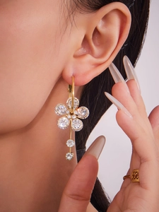 Close-up of 18k gold plated flower drop earrings with 5A zircons on a model